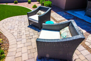 Outdoor wicker arm chairs on paver patio